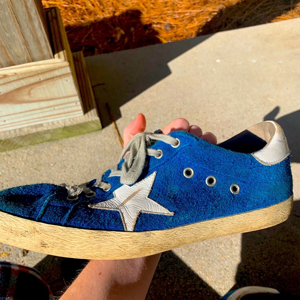 A worn pair of men’s golden goose sneakers